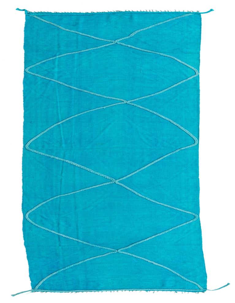 A vibrant blue 11 ft runner rug with a subtle geometric tribal pattern made from braided wool, perfect for a hallway.