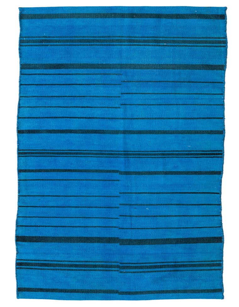 A vibrant 8 ft blue wool runner rug with horizontal black stripes and abstract tribal patterns, ideal for a hallway or kitchen.