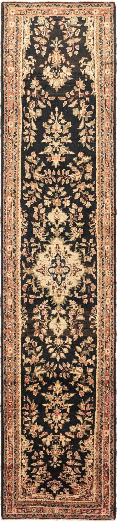 A long 16 ft runner rug in a tribal Persian style, featuring a dark blue field with intricate floral and medallion patterns in cream, rust, and light blue, framed by a multi-layered border.