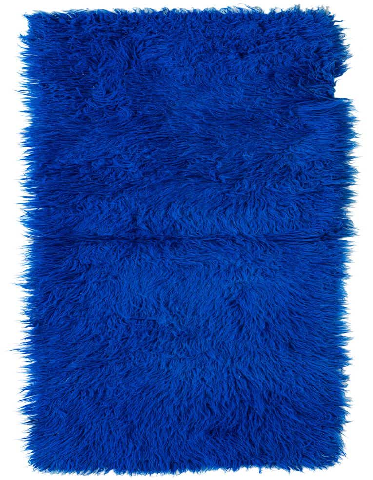 A vibrant 8 ft blue shag runner rug with a thick, plush pile, perfect for a hallway.