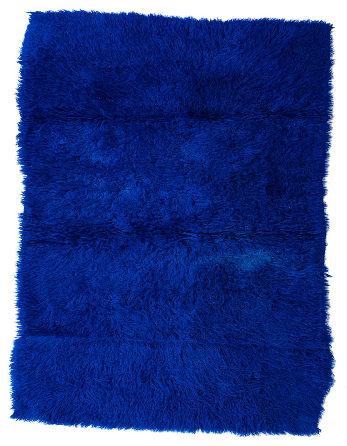 A vibrant blue 6 ft runner rug with a plush shag pile, handmade from wool, ideal for a hallway.