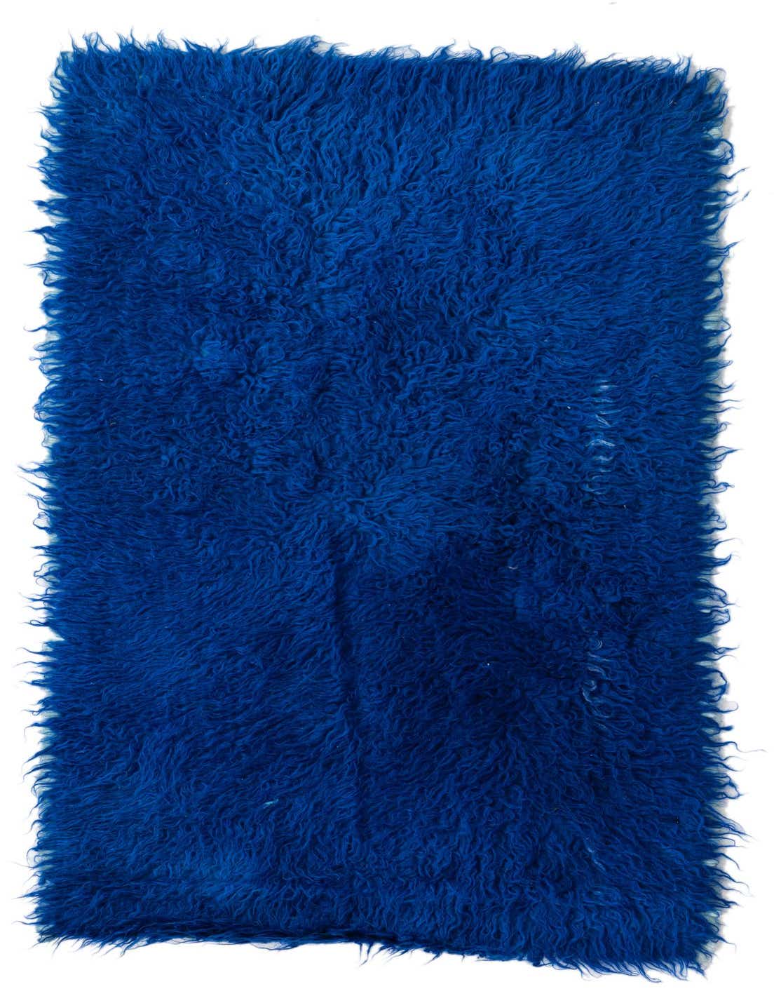 A vibrant blue 4 ft runner rug with a plush, shaggy texture, perfect for a hallway.
