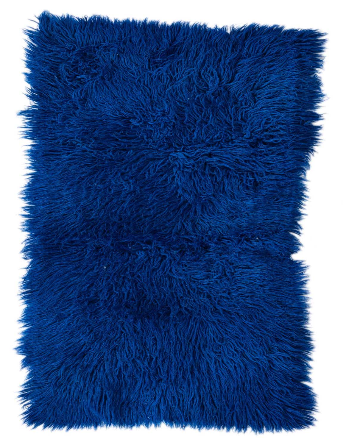 A vibrant blue 4 ft runner rug with a plush shag pile, perfect for adding a pop of color to a hallway.