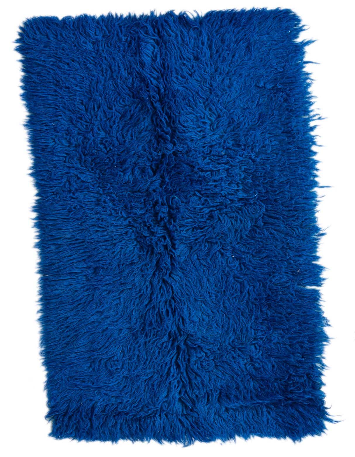 A vibrant blue 4 ft shag runner rug with a thick, plush pile, perfect for adding warmth to a hallway.