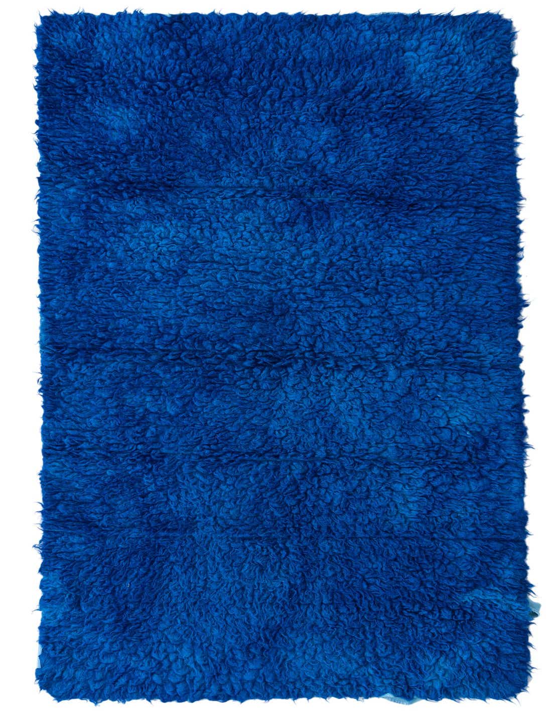 A plush, handmade 6 ft runner rug in a vibrant royal blue, featuring a shaggy texture, perfect for a hallway.