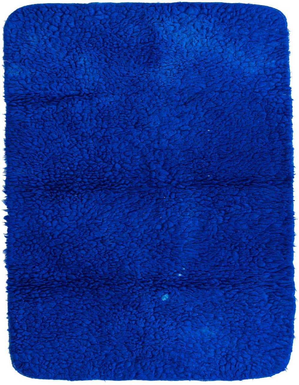 A plush, handmade 6 ft runner rug in a vibrant solid blue color with a shag pile, ideal for a hallway.