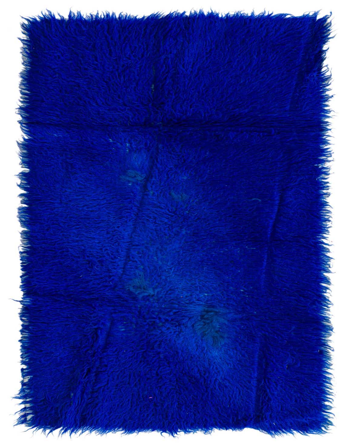 A vibrant blue 4 ft runner rug with a plush shag pile, handmade from wool, perfect for a hallway.