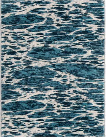 A 12 ft runner rug with a modern abstract pattern in varying shades of blue and white, resembling ocean waves or seafoam.