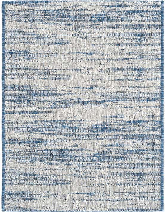 An 8 ft runner rug from the Outdoor Modern collection, featuring a textured blue and white abstract pattern with a flatweave.
