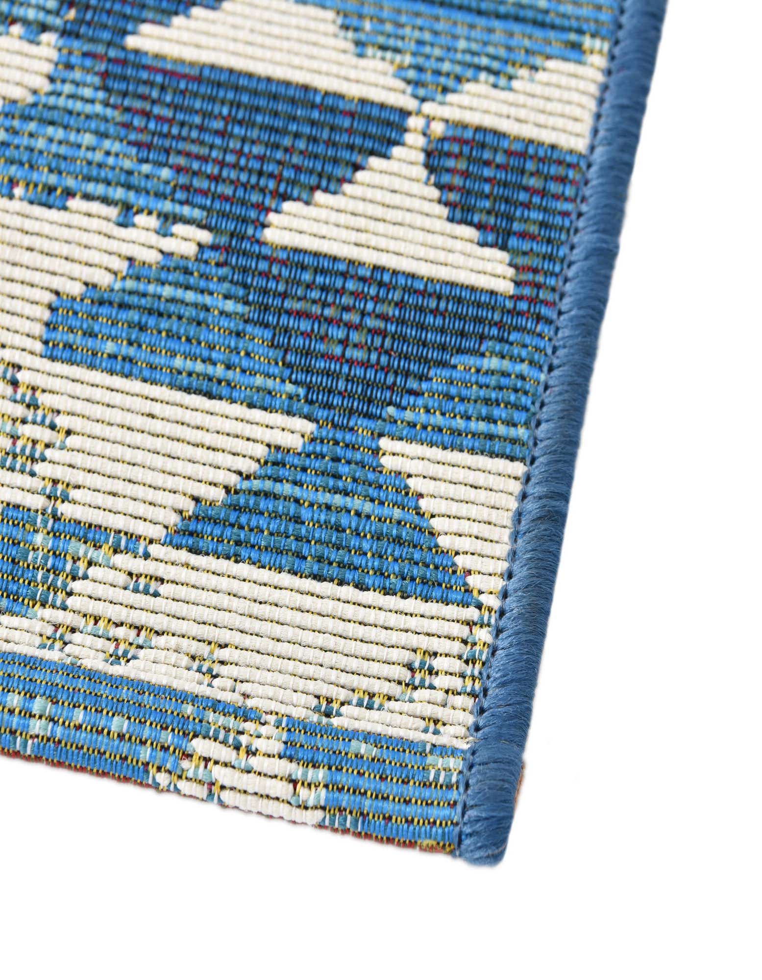 A 6 ft runner rug with a vibrant blue and white Southwestern tribal pattern, ideal for a hallway or patio.