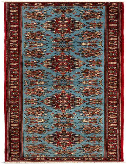 A 13 ft Qom Persian runner rug in shades of blue and red, featuring an intricate floral and medallion pattern.