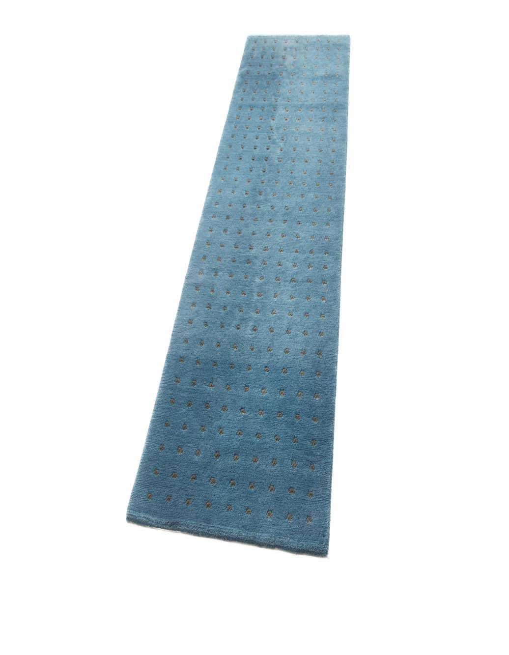 A 10 ft blue wool runner rug with a subtle modern dot pattern, perfect for a hallway.