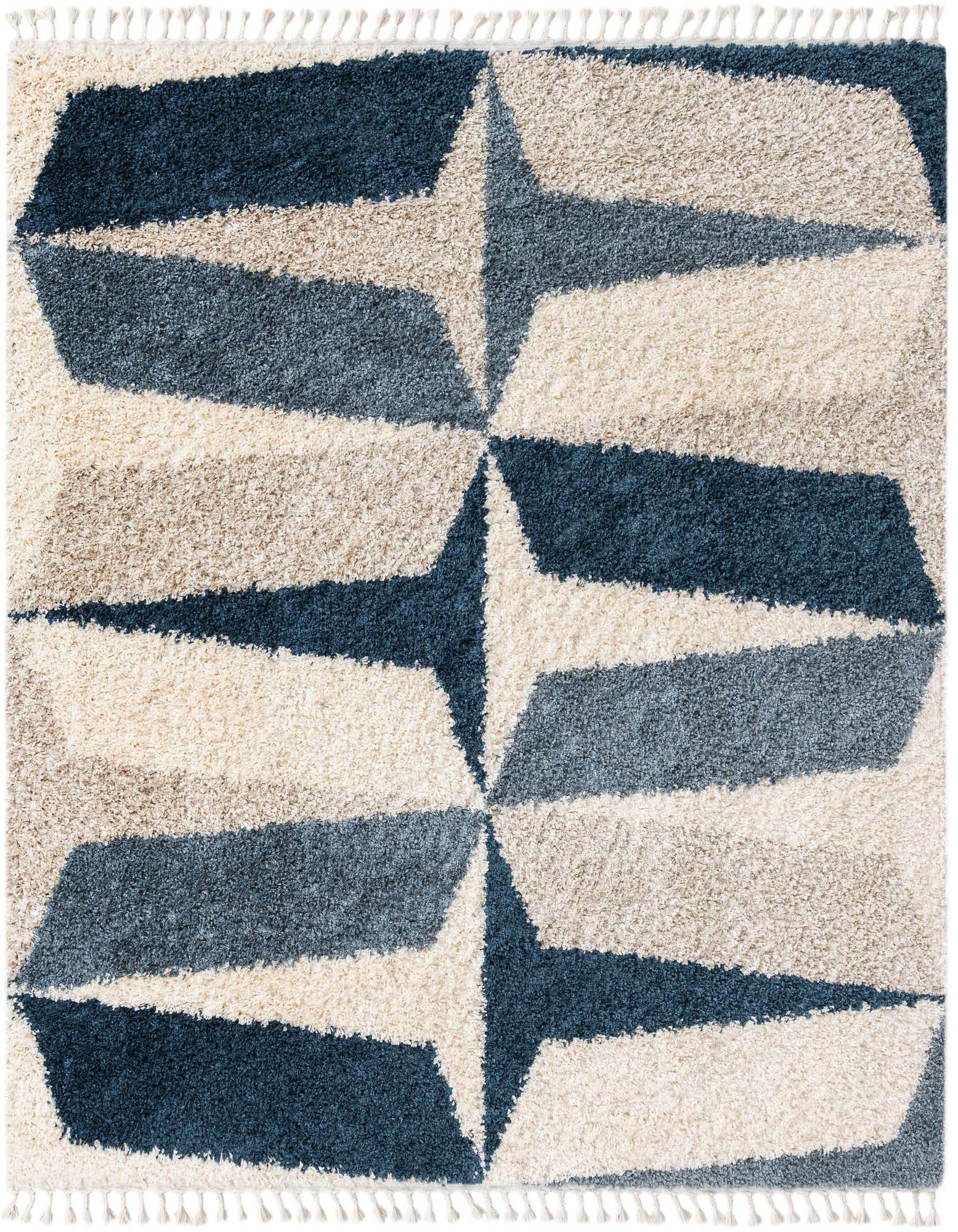 A square 7' 10 x 7' 10 Athena Shag rug featuring a modern abstract pattern in varying shades of blue, light blue, and cream, with a plush shag pile and decorative tassels.