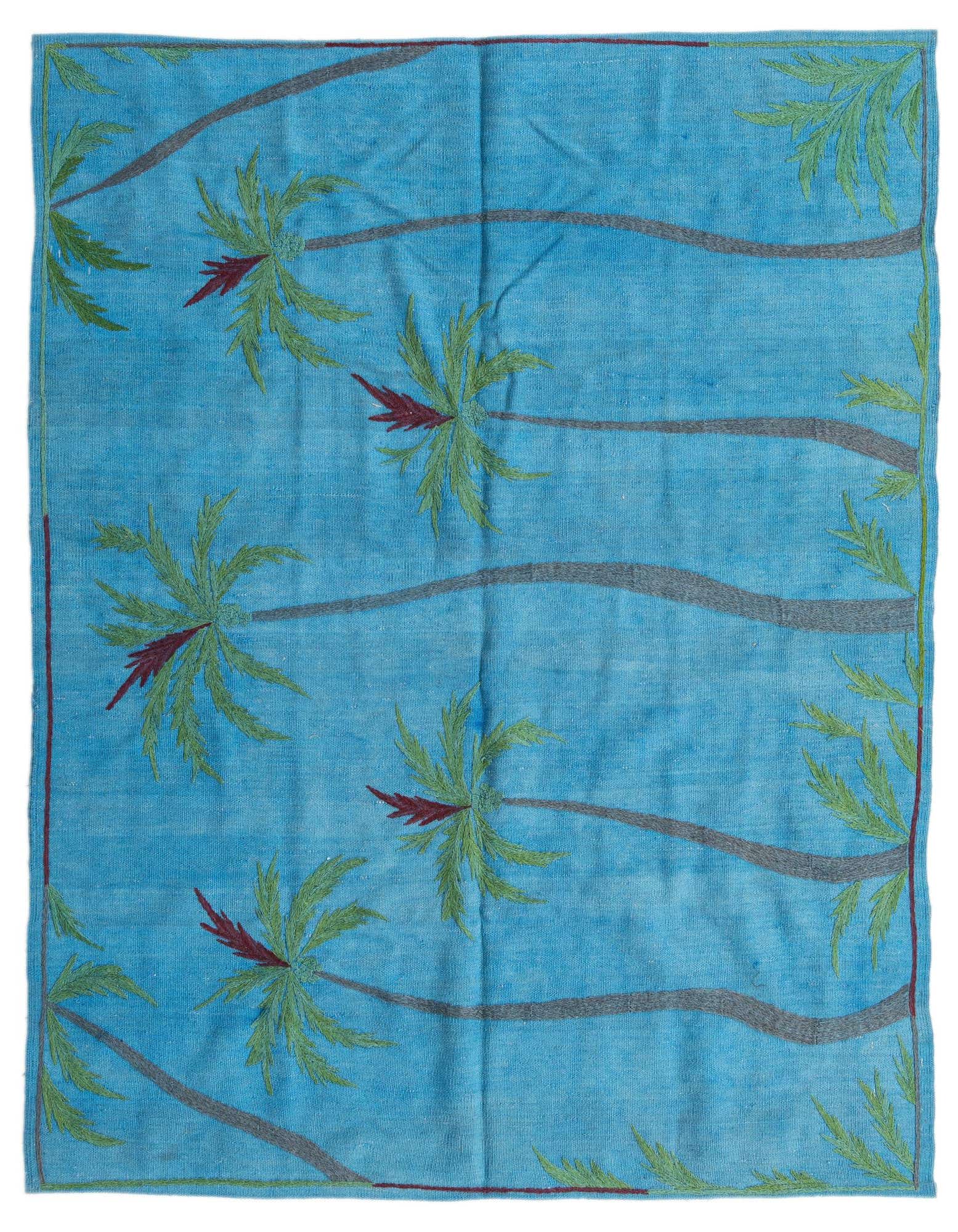 A 4'11" x 5'10" square blue Kilim Suzani rug with a modern tribal pattern of green and red palm trees.