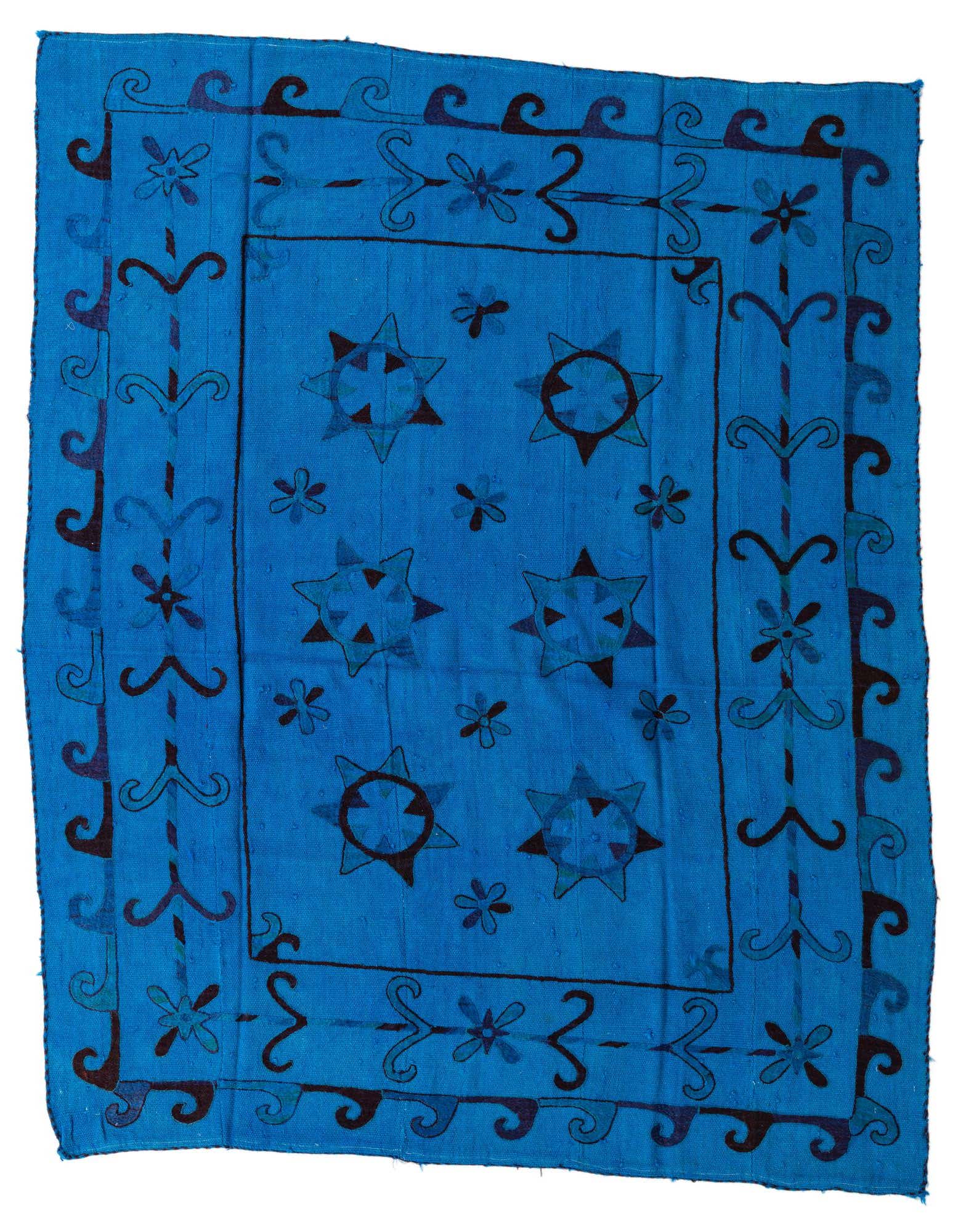A 6' 0 x 7' 3 square blue Kilim Suzani rug with a tribal pattern of dark blue stars and floral motifs, and a decorative border.