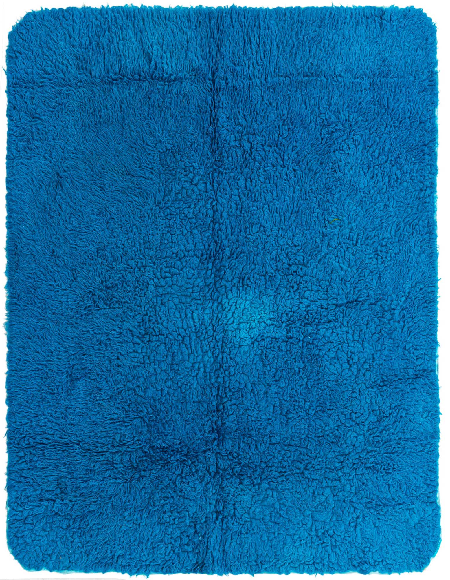A plush, square 5' 7 x 6' 0 blue shag rug with a textured, tribal-modern pattern, perfect for an indoor living space.