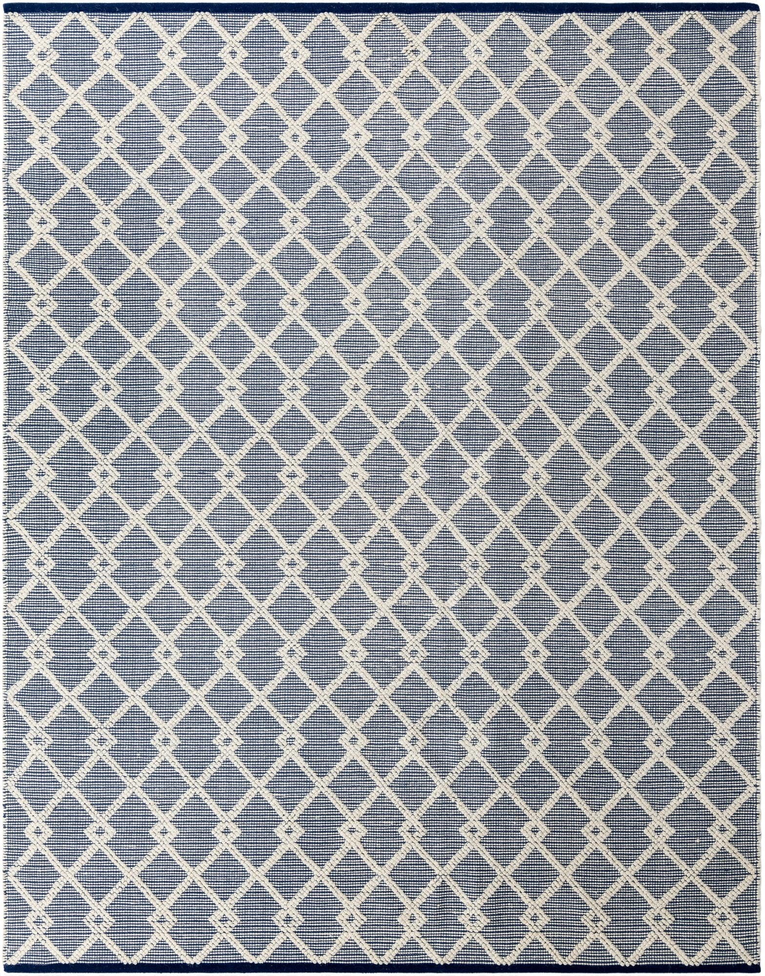 An 8x10 rectangular blue and white flatweave rug with a repeating geometric diamond pattern, suitable for a living room.