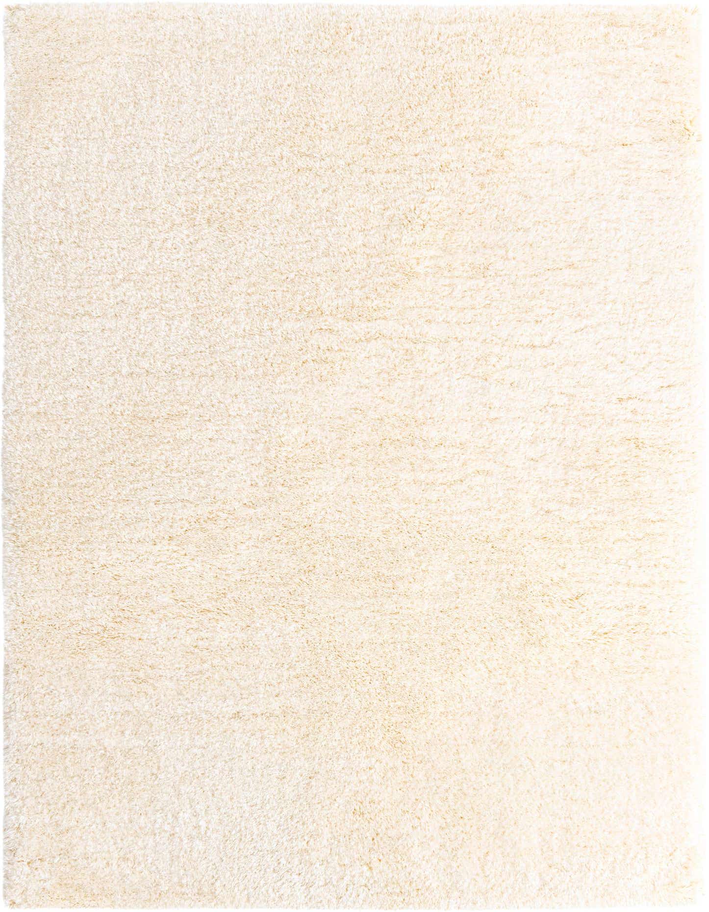A soft, rectangular 7x10 ivory shag rug with a plush, textured pile, perfect for a cozy living room or bedroom.