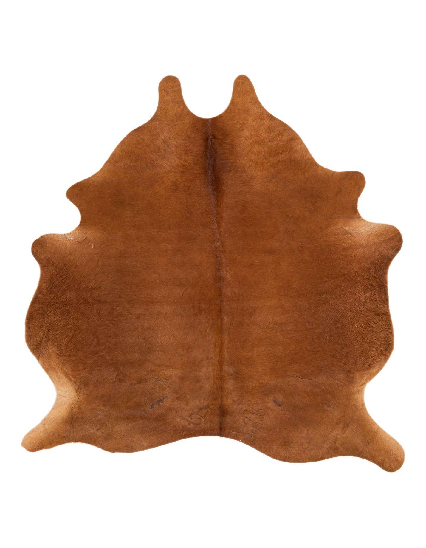 A 5' 9 x 6' 5 freeform brown cowhide rug with a natural, irregular shape and flat, textured pile.