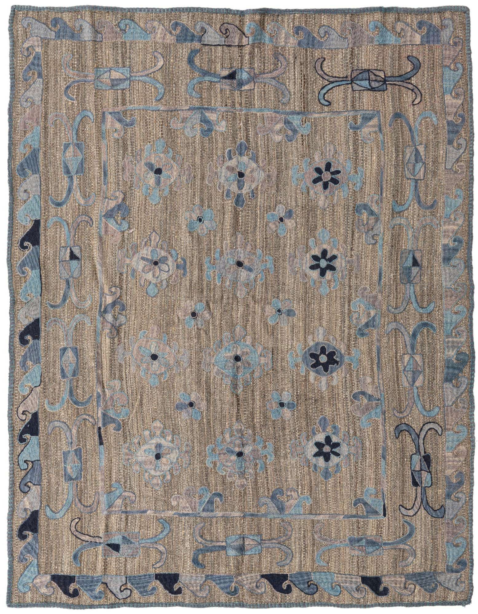 A 5x8 rectangular Kilim Suzani rug featuring a tan and brown flatweave background with intricate blue, gray, and light brown tribal floral patterns.