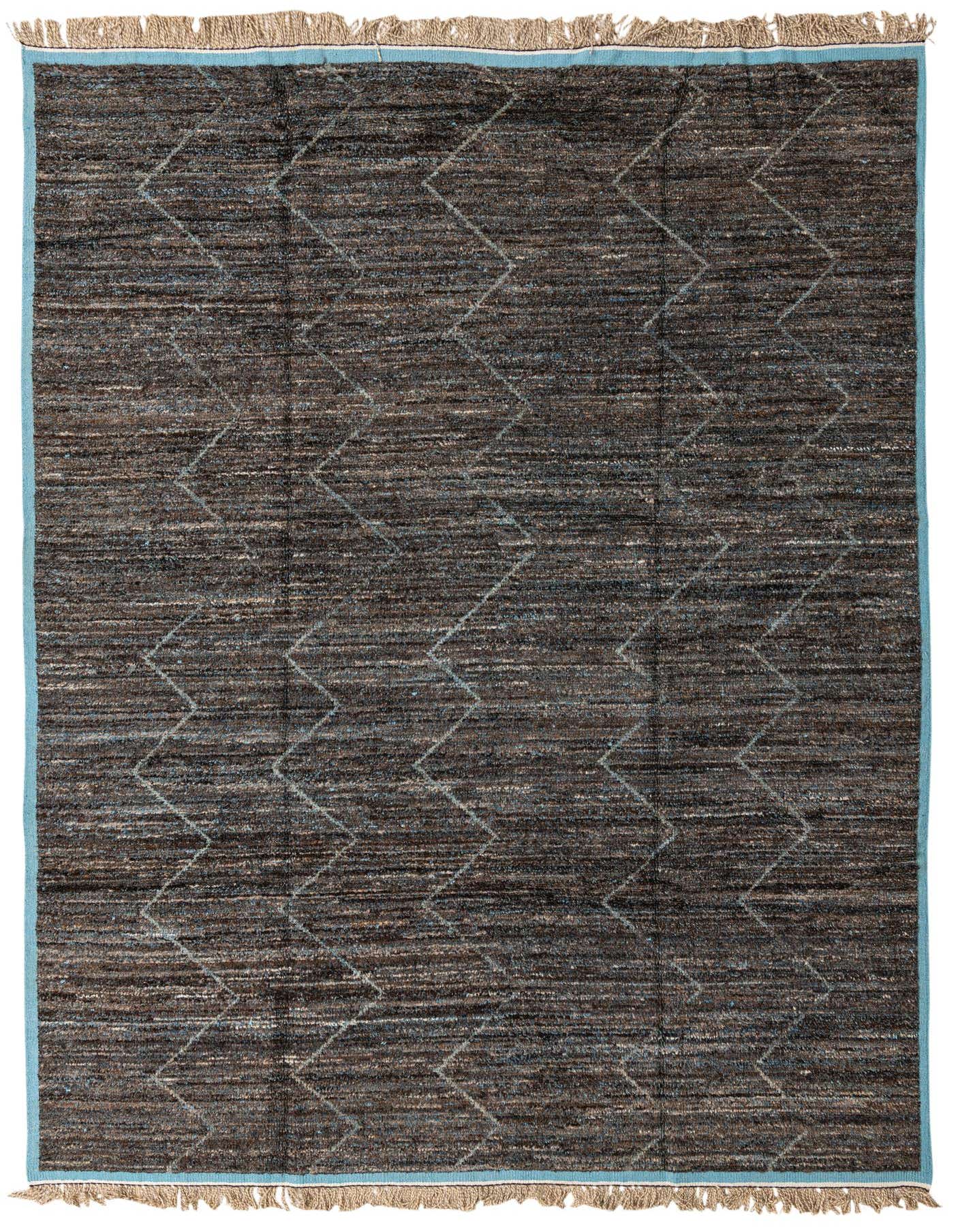 A 9x12 rectangular brown shag rug with subtle gray tribal diamond patterns and light blue borders, ideal for a living room.
