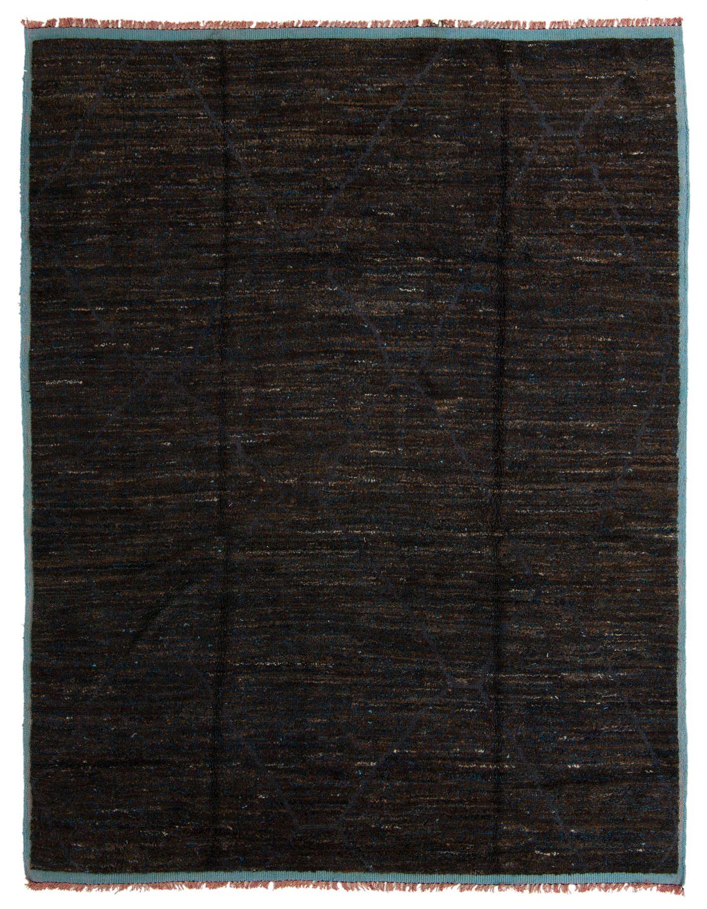 A 9x12 rectangular brown shag rug with subtle tribal patterns and a light blue border, handmade from wool.