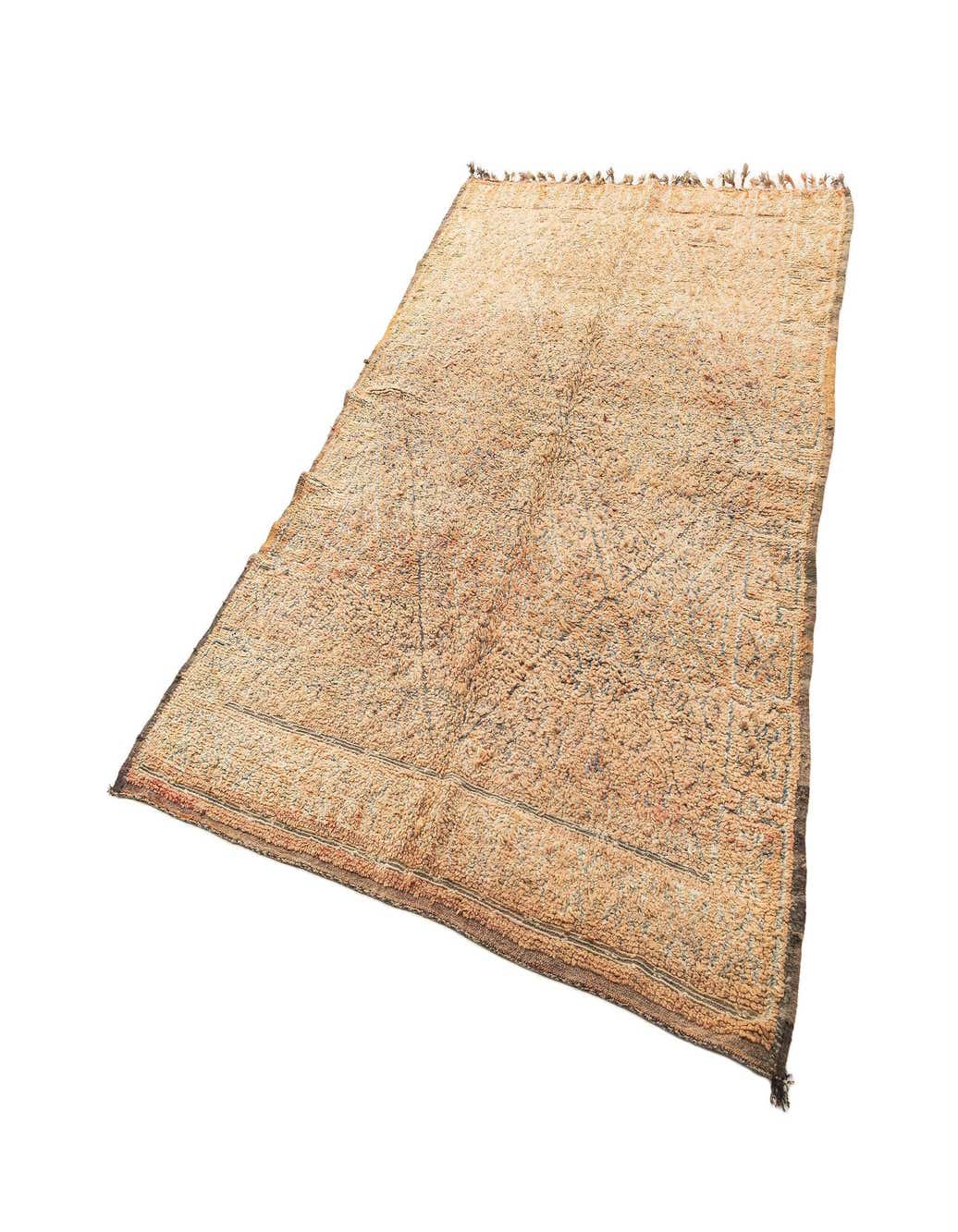 A 6x9 rectangular Berber wool rug in varying shades of brown and tan with a subtle geometric pattern, suitable for a living room.