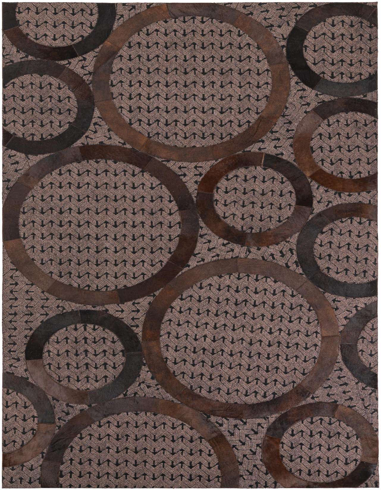A rectangular 5x8 modern area rug featuring large, overlapping brown cowhide circles on a tan and black abstract patterned background.