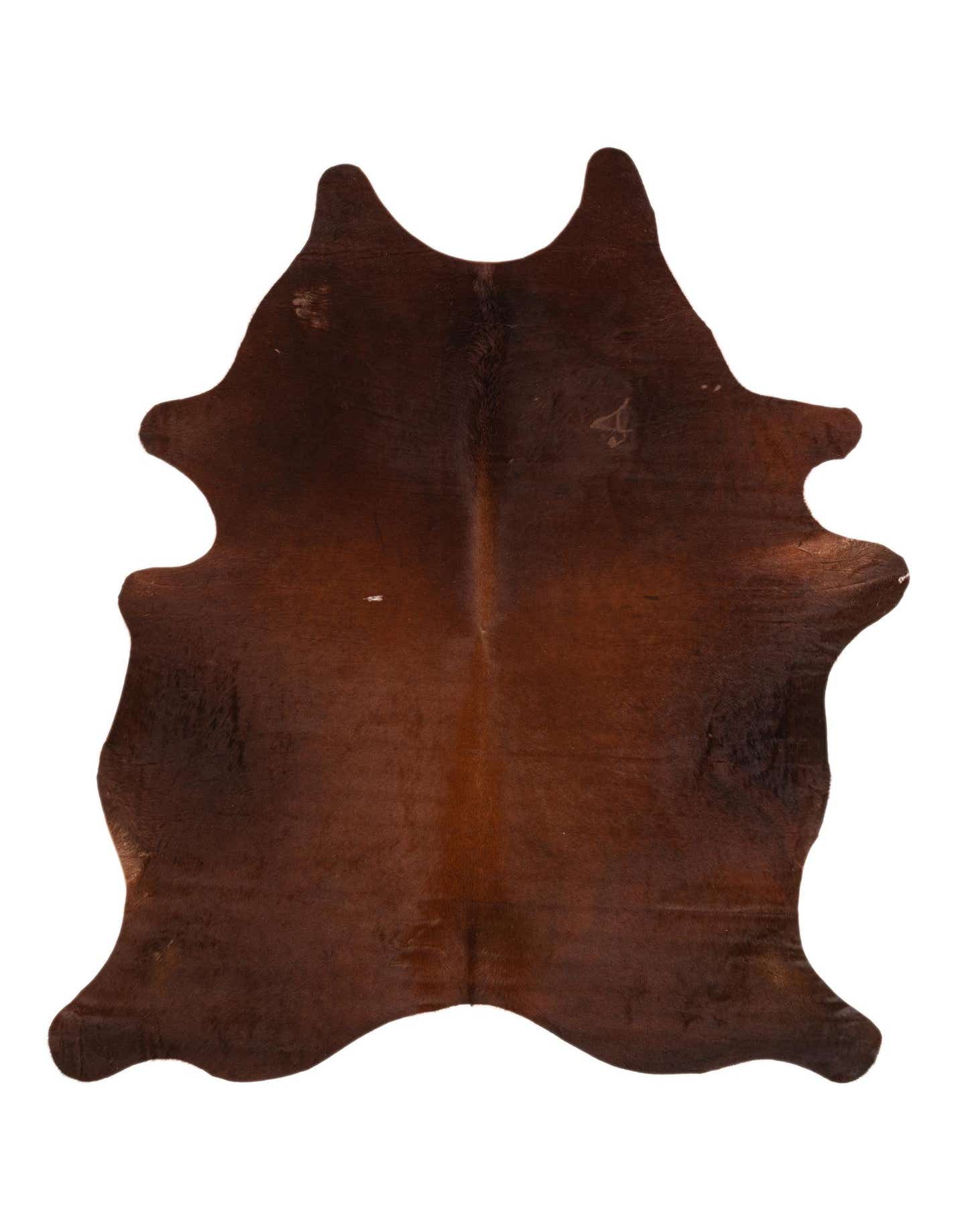 A 5x7 rectangular cowhide rug in varying shades of brown and tan, featuring a natural, irregular shape.