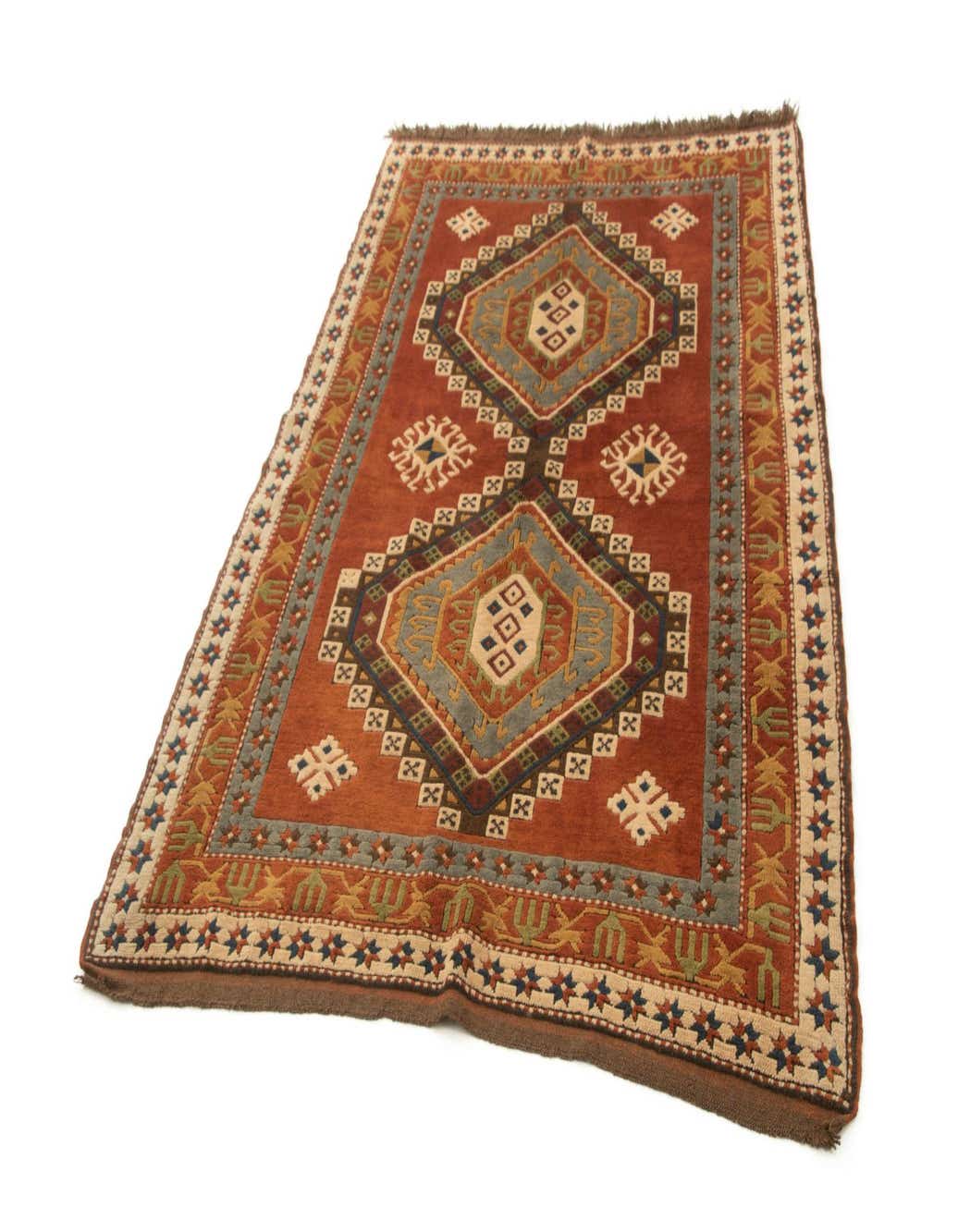 A 5x8 rectangular Kars tribal wool rug in browns and tans with geometric patterns, handmade for indoor use.