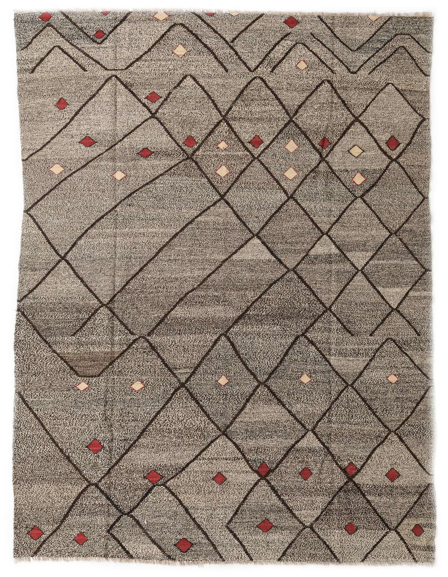 A 7x10 rectangular Kilim Modern wool rug featuring a brown tribal diamond pattern on a tan background with small red and cream accents.