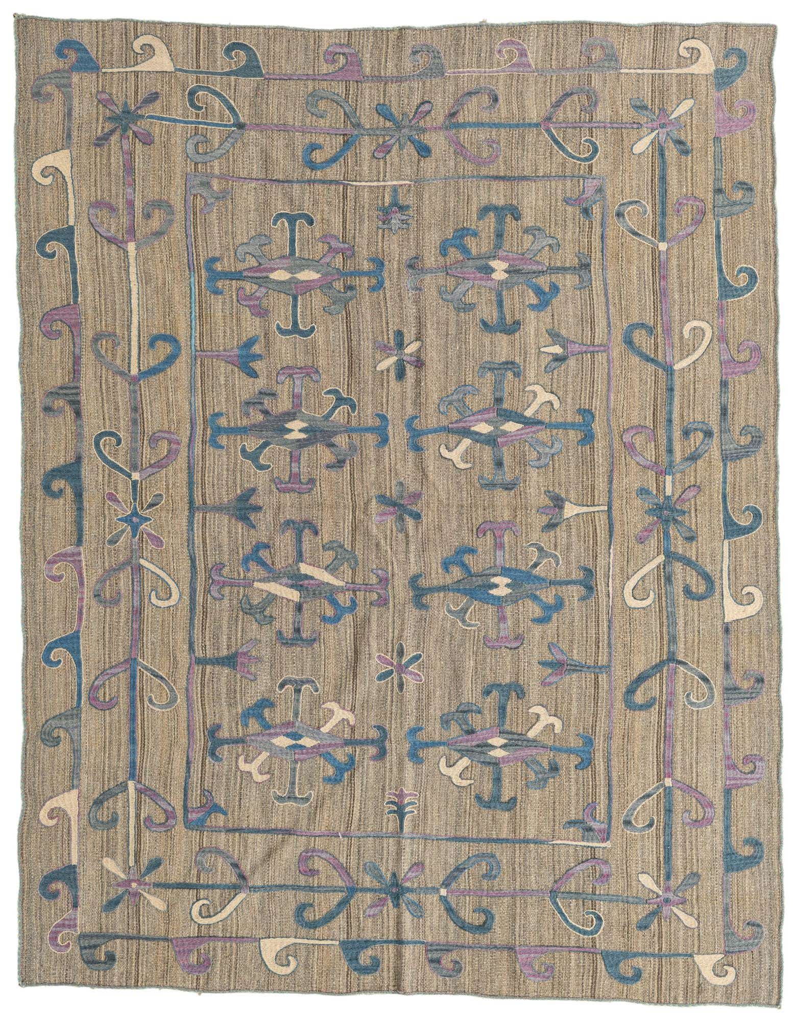 A 5x8 rectangular Kilim Suzani rug with a flatweave texture. It features a brown and tan striped background with tribal and abstract patterns in shades of blue, purple, and cream.