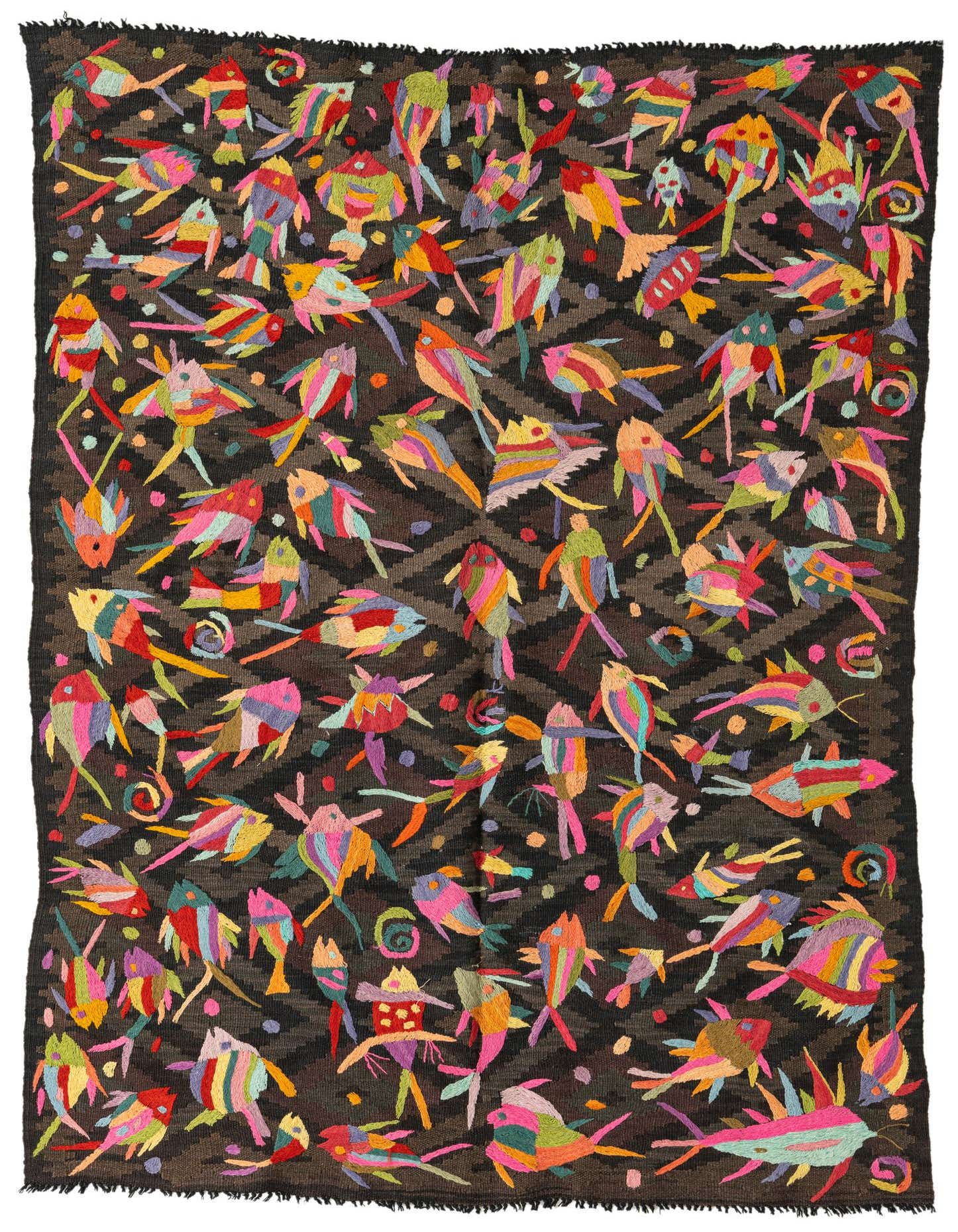 A rectangular 4x6 Kilim Suzani wool rug featuring a dark brown background with a subtle tribal pattern, densely embroidered with colorful, whimsical fish in various bright hues like pink, green, yellow, and blue.