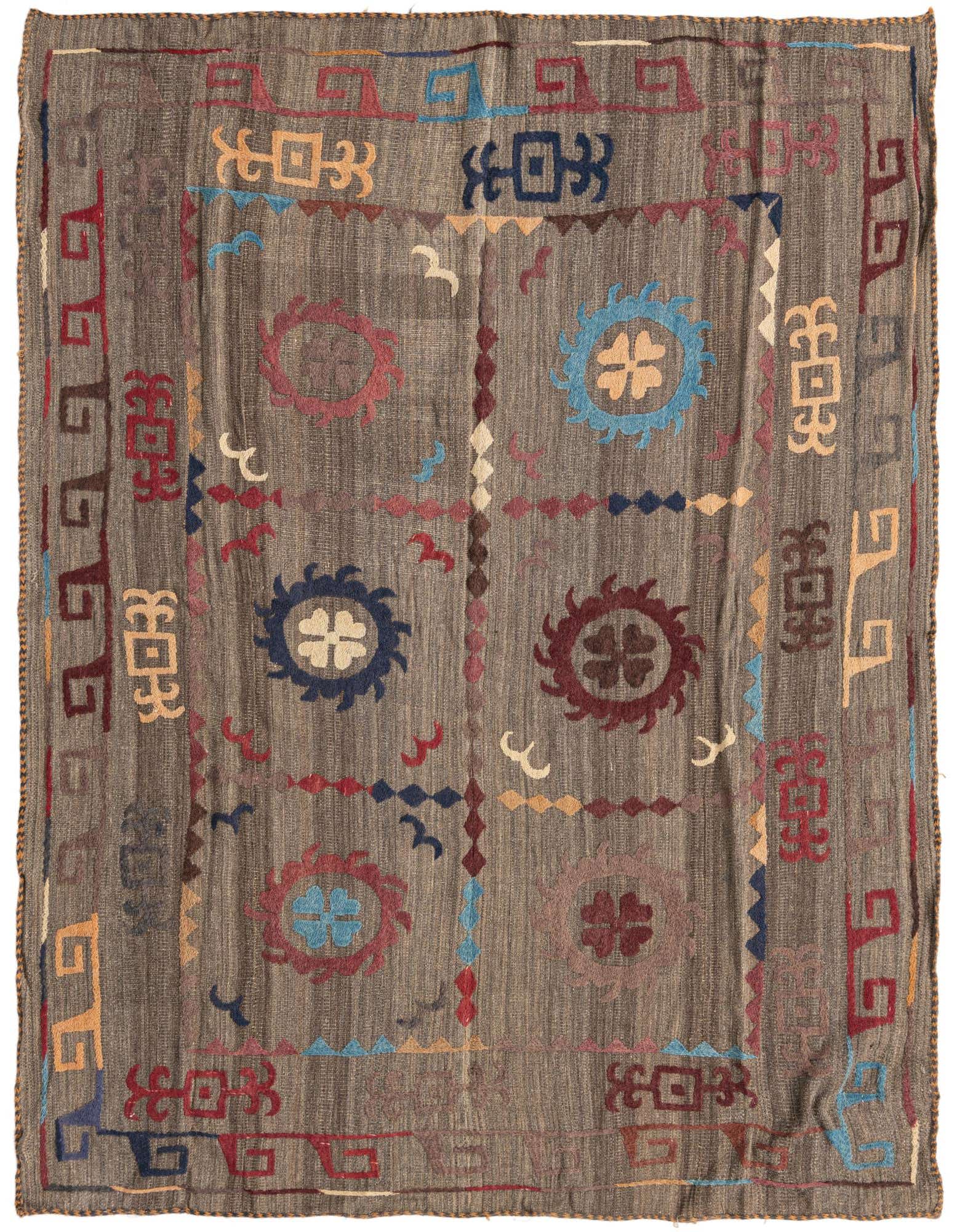 A 4x6 rectangular brown flatweave rug with a colorful tribal Suzani pattern, featuring abstract medallions and geometric borders.