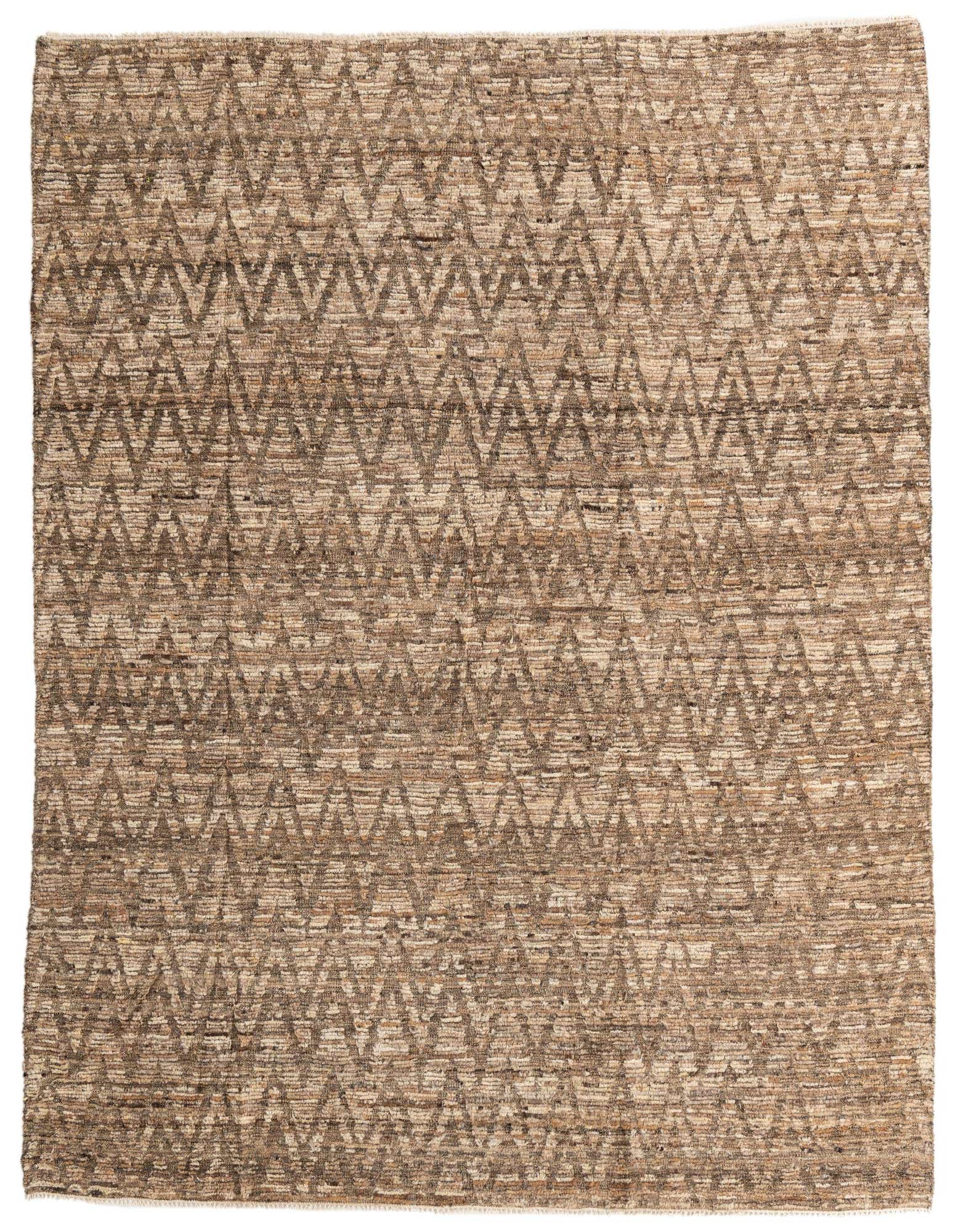 A rectangular 8x10 brown and tan tribal wool shag rug with a modern zigzag pattern, suitable for a living room.