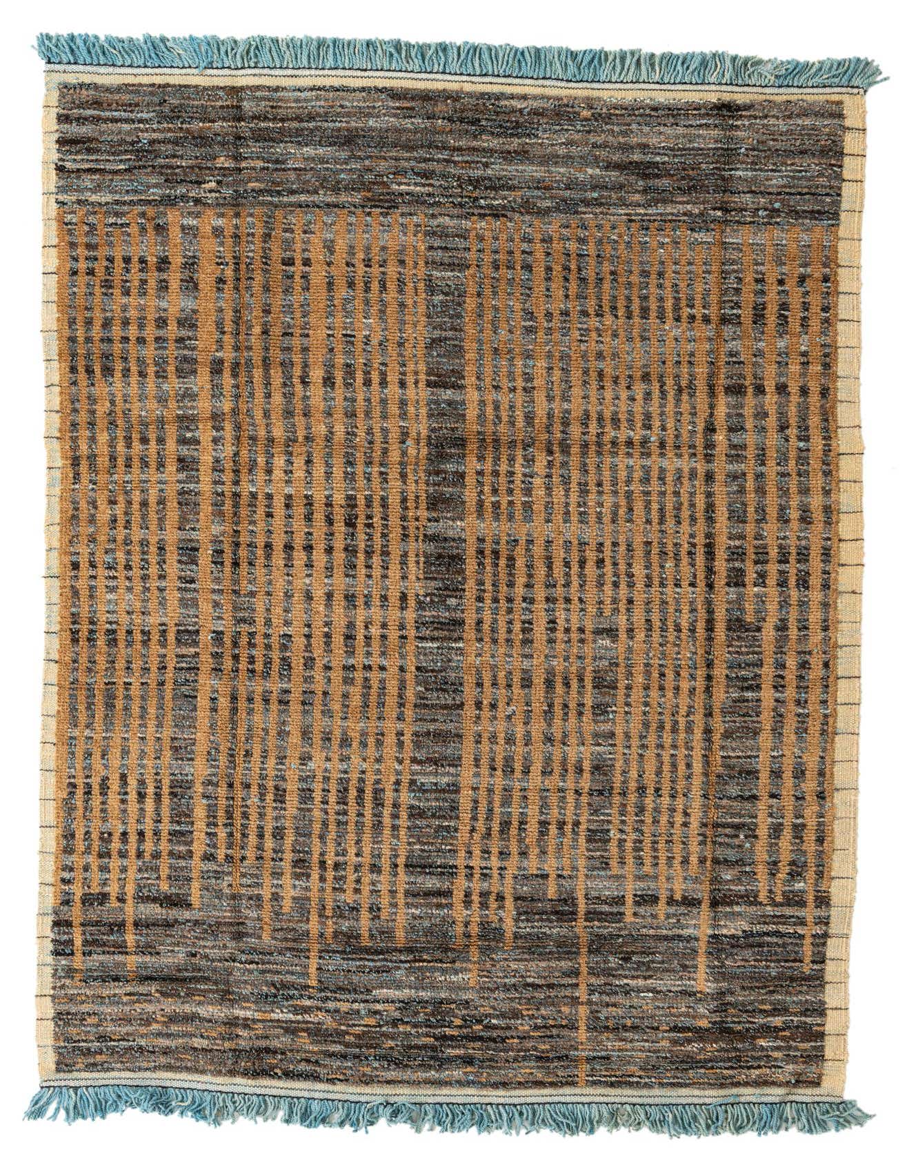 A 6x9 rectangular Moroccan shag rug with a tribal, abstract pattern in varying shades of brown and tan, featuring light blue fringe.