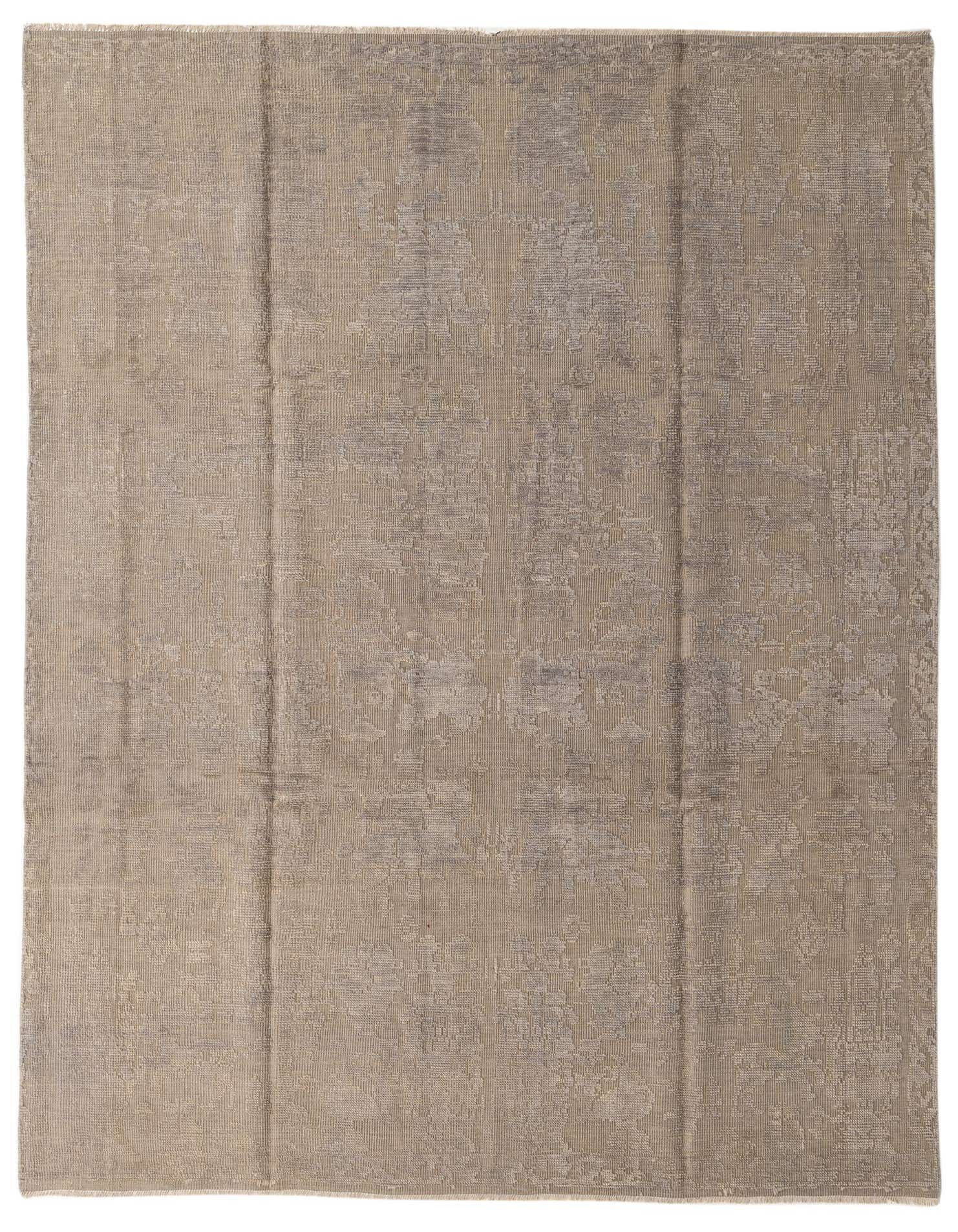 An 8x11 rectangular shag rug in shades of brown and tan, featuring a subtle abstract tribal pattern.