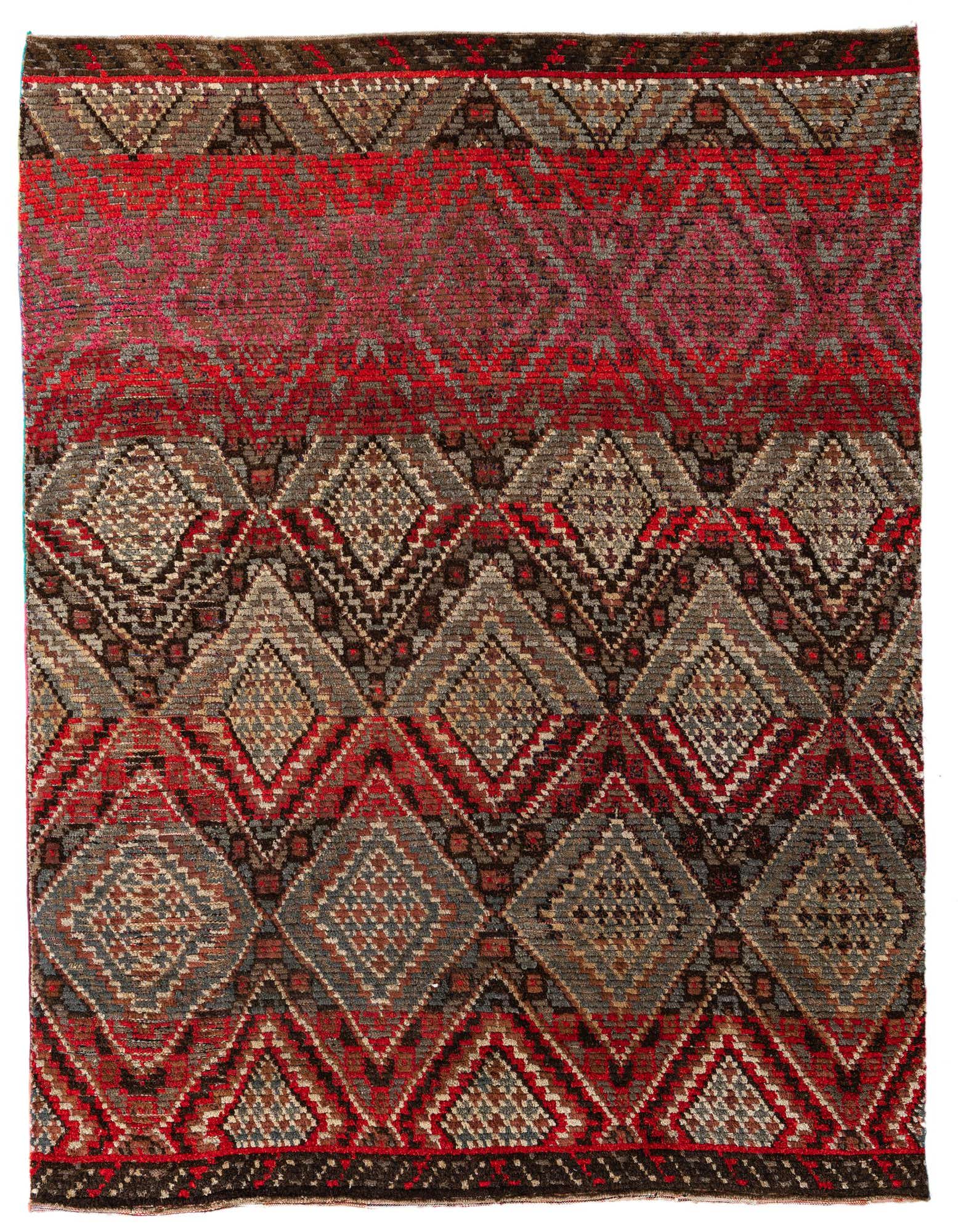 A 7x10 rectangular Moroccan shag rug with a tribal pattern in shades of brown, tan, and red.