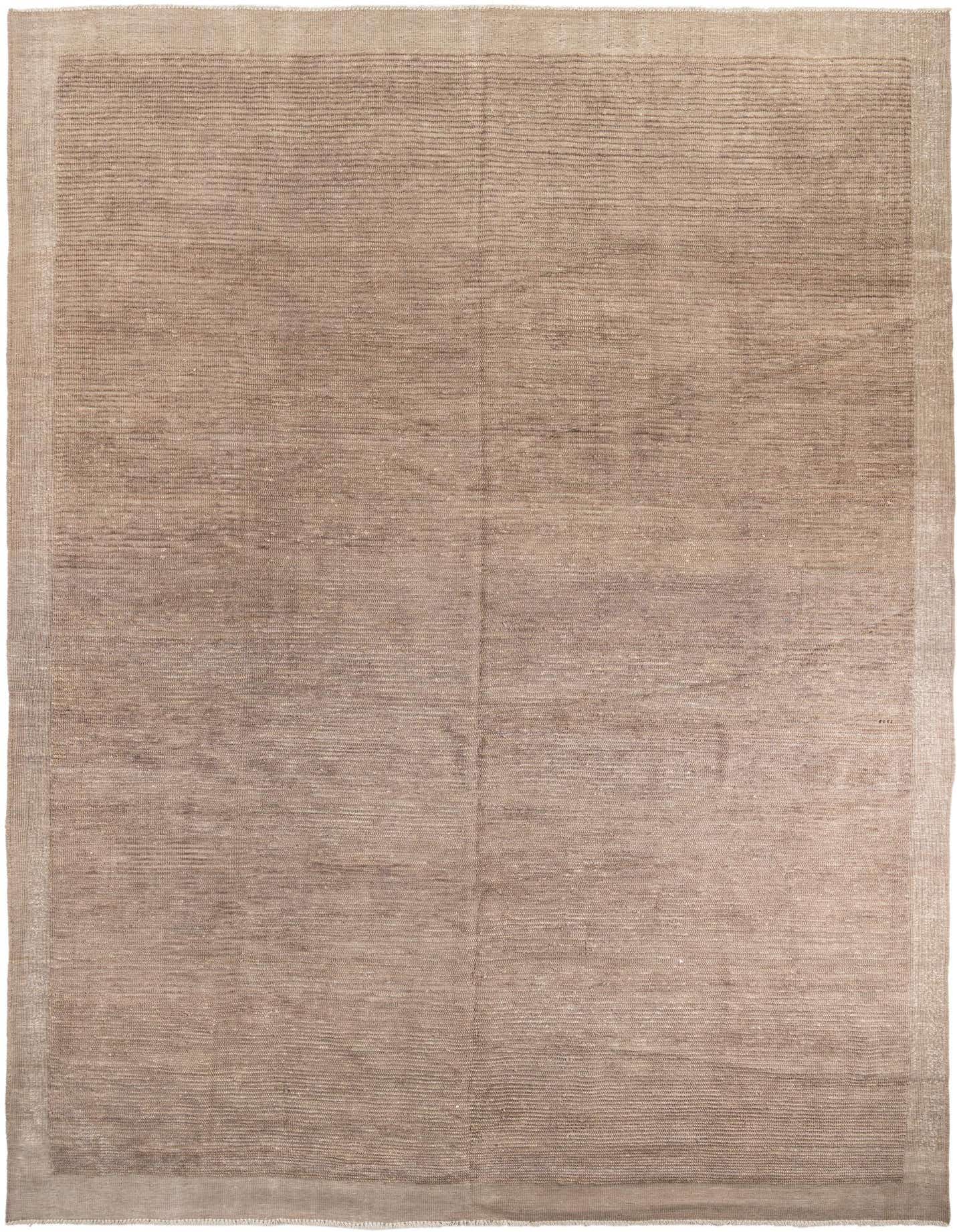 A large 10x14 rectangular shag rug in varying shades of brown and tan, featuring a subtle tribal pattern and a distinct border.