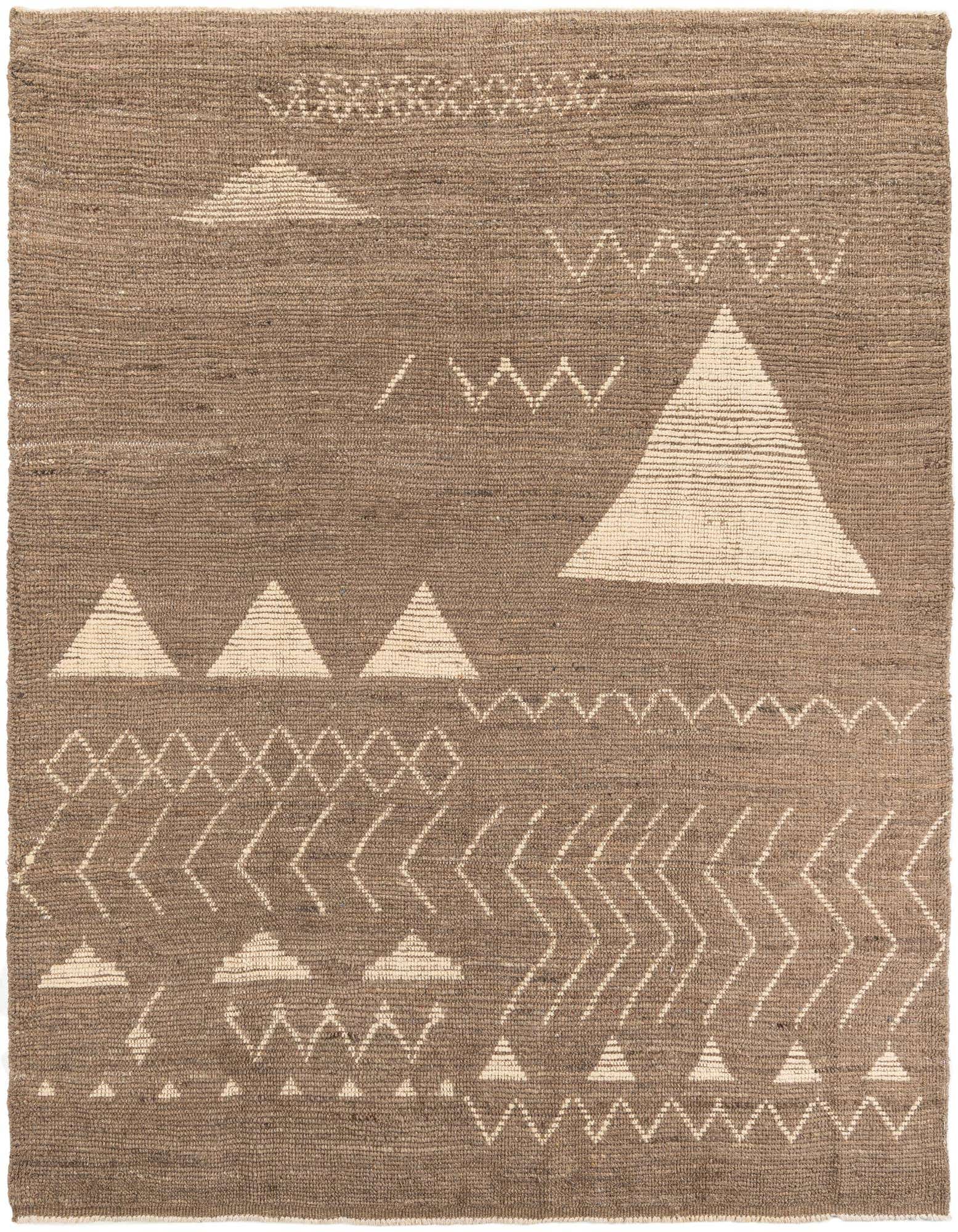 A brown 8x10 rectangular wool shag rug with a modern tribal pattern featuring cream-colored geometric shapes and zigzags.