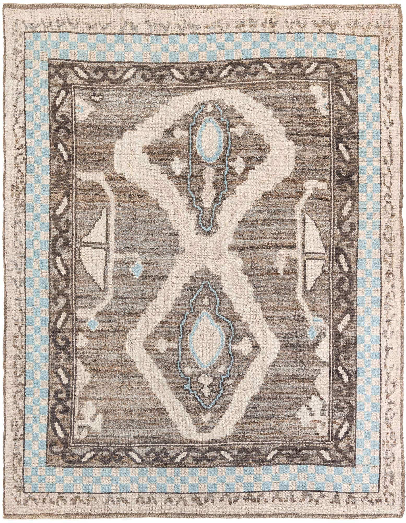 A rectangular 8x10 Moroccan shag rug featuring a tribal medallion pattern in browns, tans, and light blue accents.