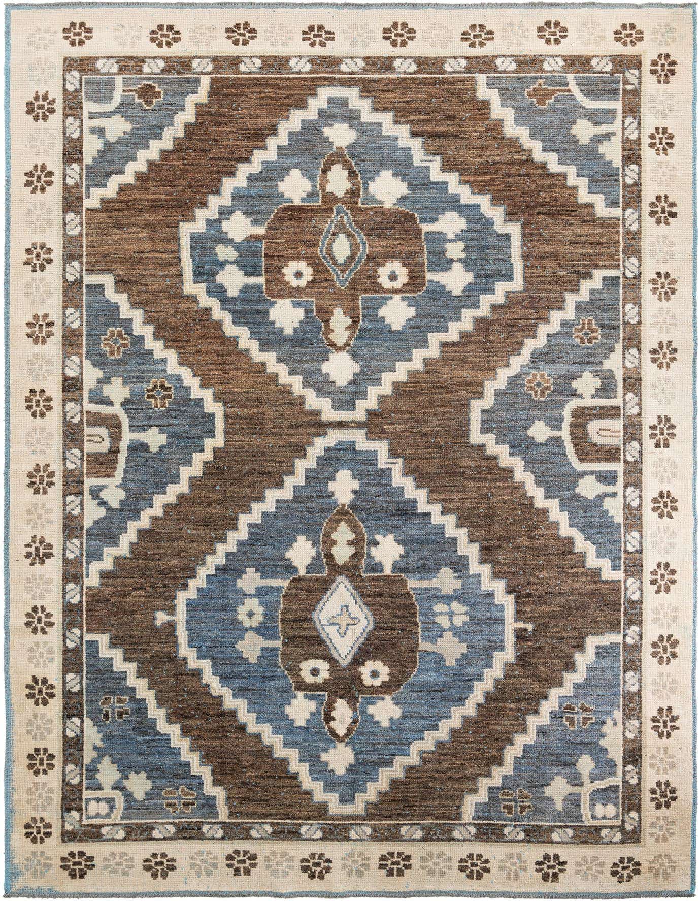 A 10x14 rectangular brown and blue Moroccan tribal wool shag rug with a bold geometric medallion pattern and floral border.
