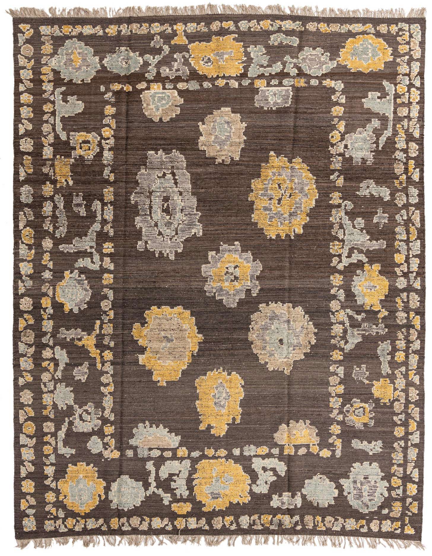 A 9x12 rectangular Oushak wool rug featuring an abstract floral pattern in tans, grays, and yellows on a dark brown background, with fringed edges.