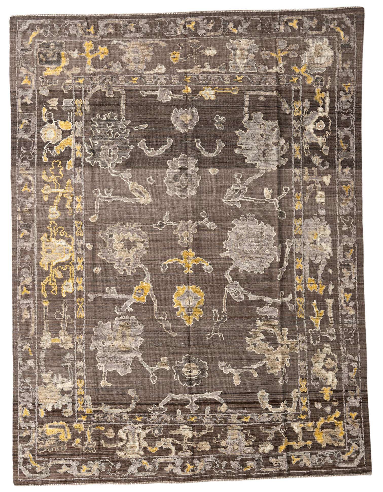 A 9x12 rectangular Oushak rug in brown with abstract modern patterns in tan and yellow.