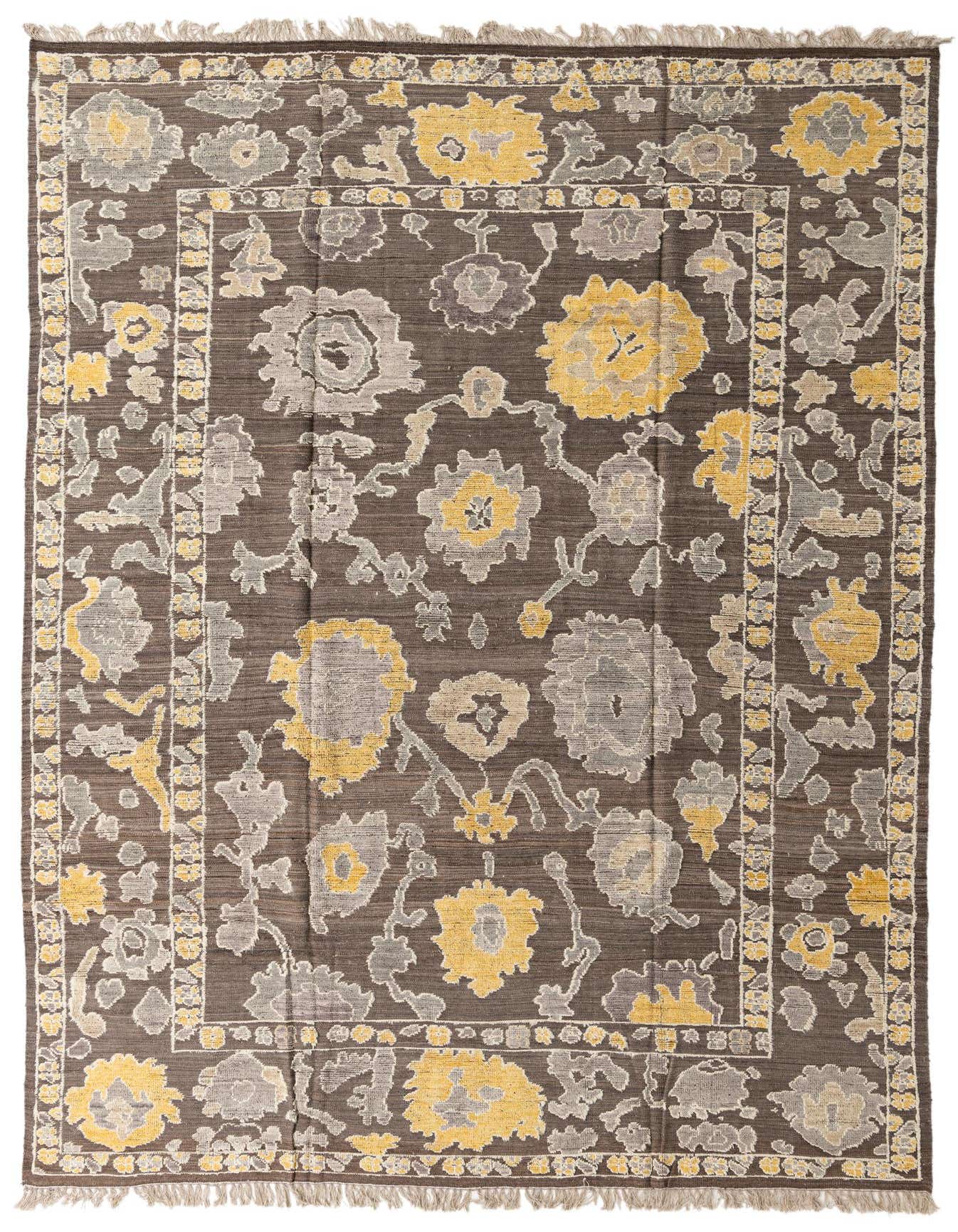A 10x14 rectangular brown wool rug with a modern Oushak pattern featuring large yellow and gray floral motifs and a decorative border.
