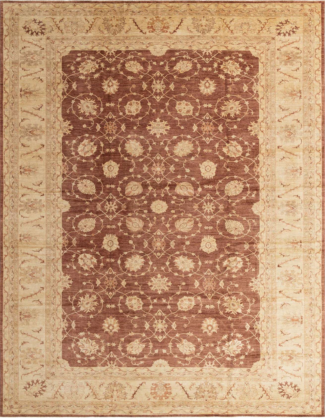 A large 13x18 rectangular Peshawar Ziegler rug with a deep brown field and intricate tan botanical patterns, framed by a wide tan border with floral motifs.