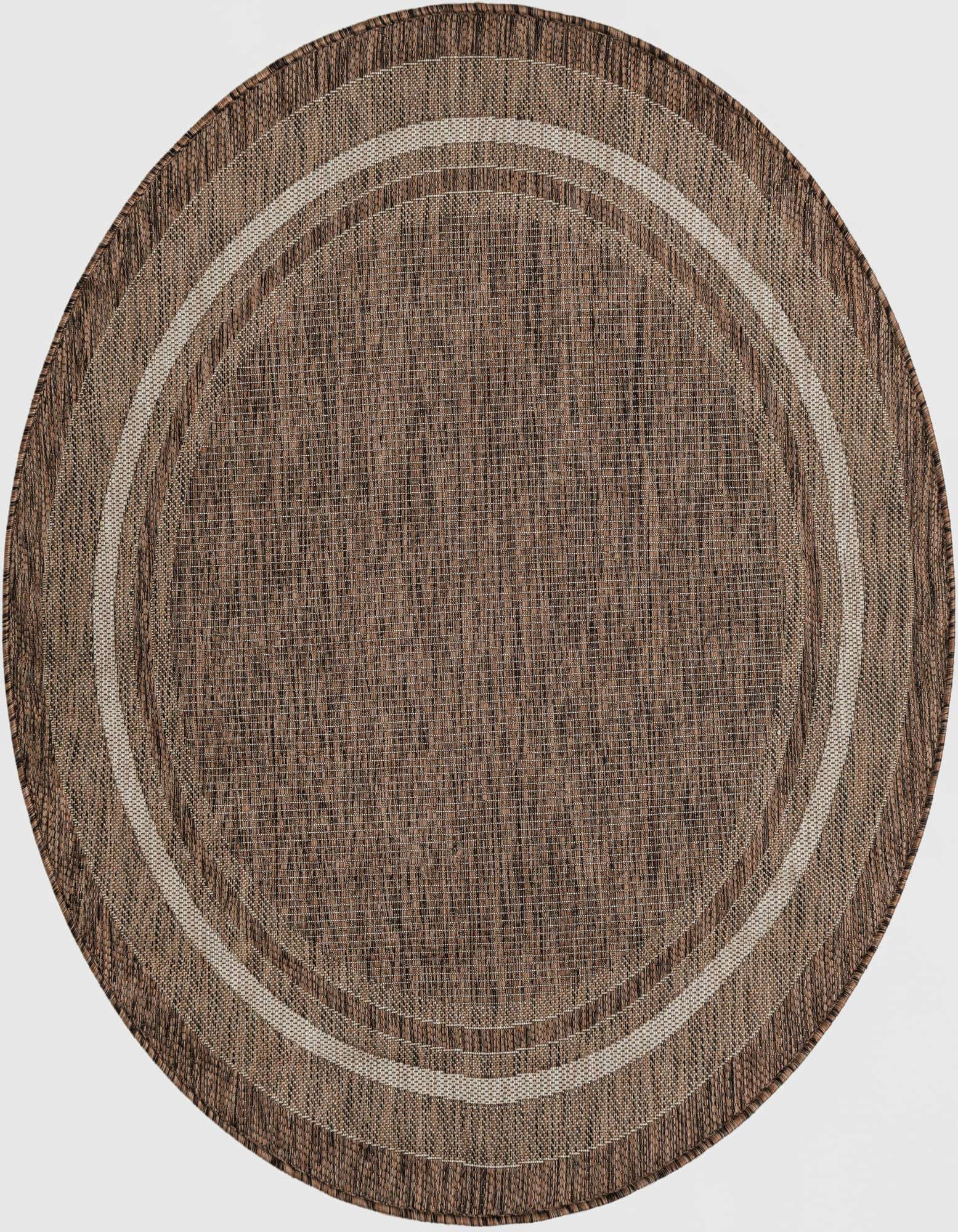 A 5' 3 round brown and tan outdoor rug with a subtle striped border, showcasing its flatweave texture.