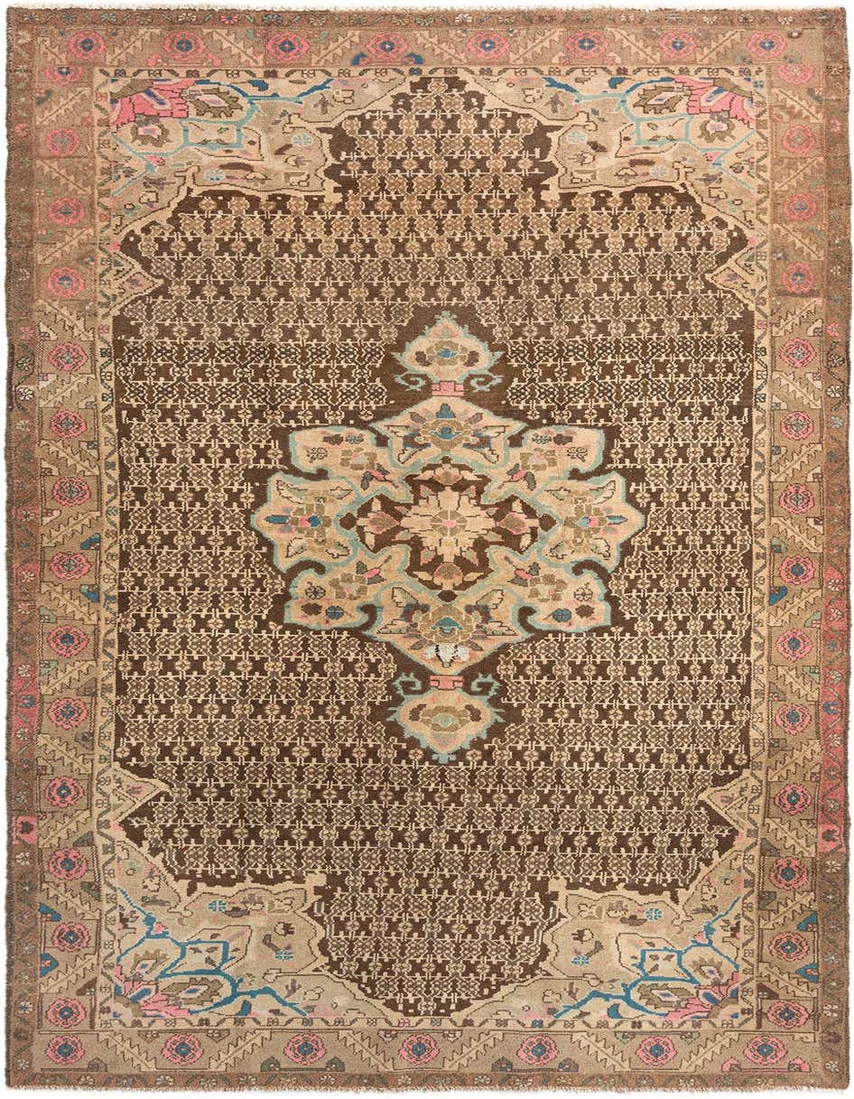 A handmade 11 ft wool Persian runner rug in browns and tans with a detailed floral medallion and intricate border, perfect for a hallway.