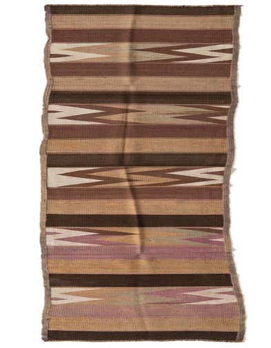 A long, narrow Kilim Fars runner rug with a flatweave, featuring brown, tan, and cream tribal patterns.