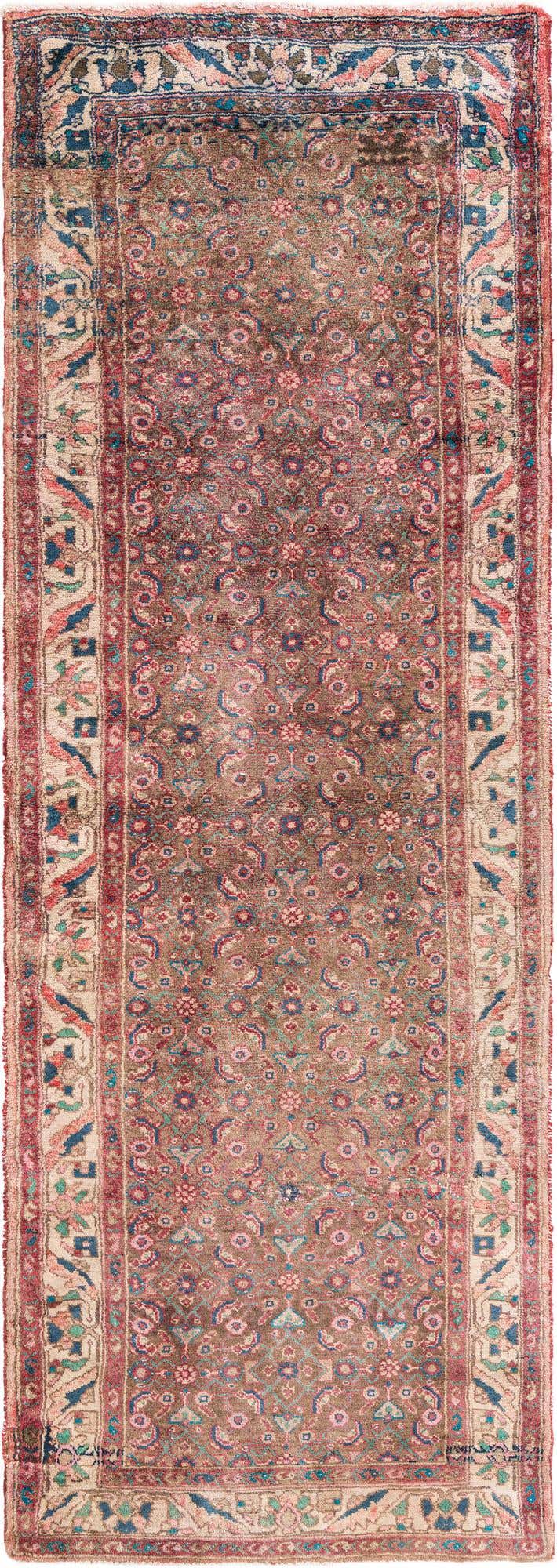 A 10 ft runner rug in brown and tan with a distressed Persian pattern, ideal for a hallway.